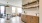 Model dining room at our apartments in Richmond, VA featuring wood shelves and wood grain floor paneling.